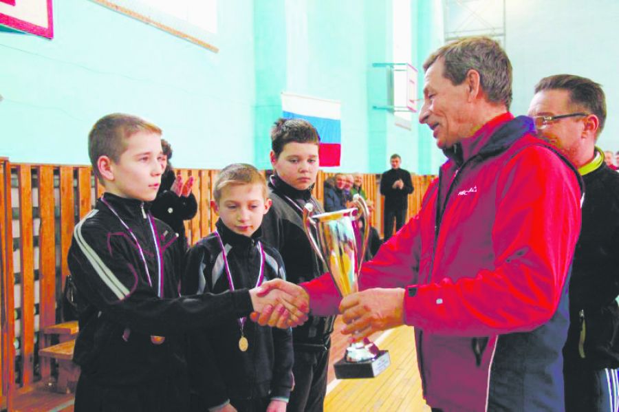 Владимир Воронин награждает юных участников городошных соревнований.  
